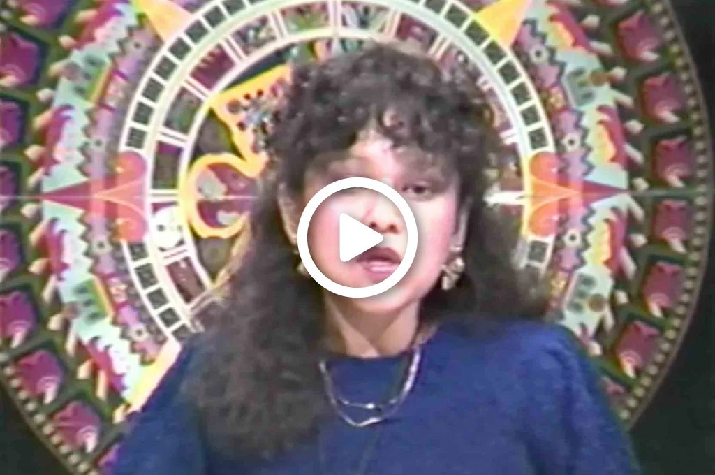 A video still of Isabel Perez Yanez in front of a colorful circular design.