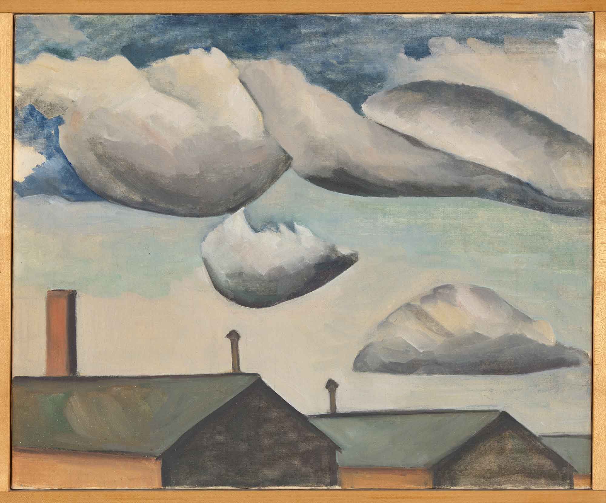 A painting titled "clouds", by Hisako Hibi. The canvas is framed with a modest wooden frame. It depicts a cloudy sky over the slanted roofs of two large buildings.